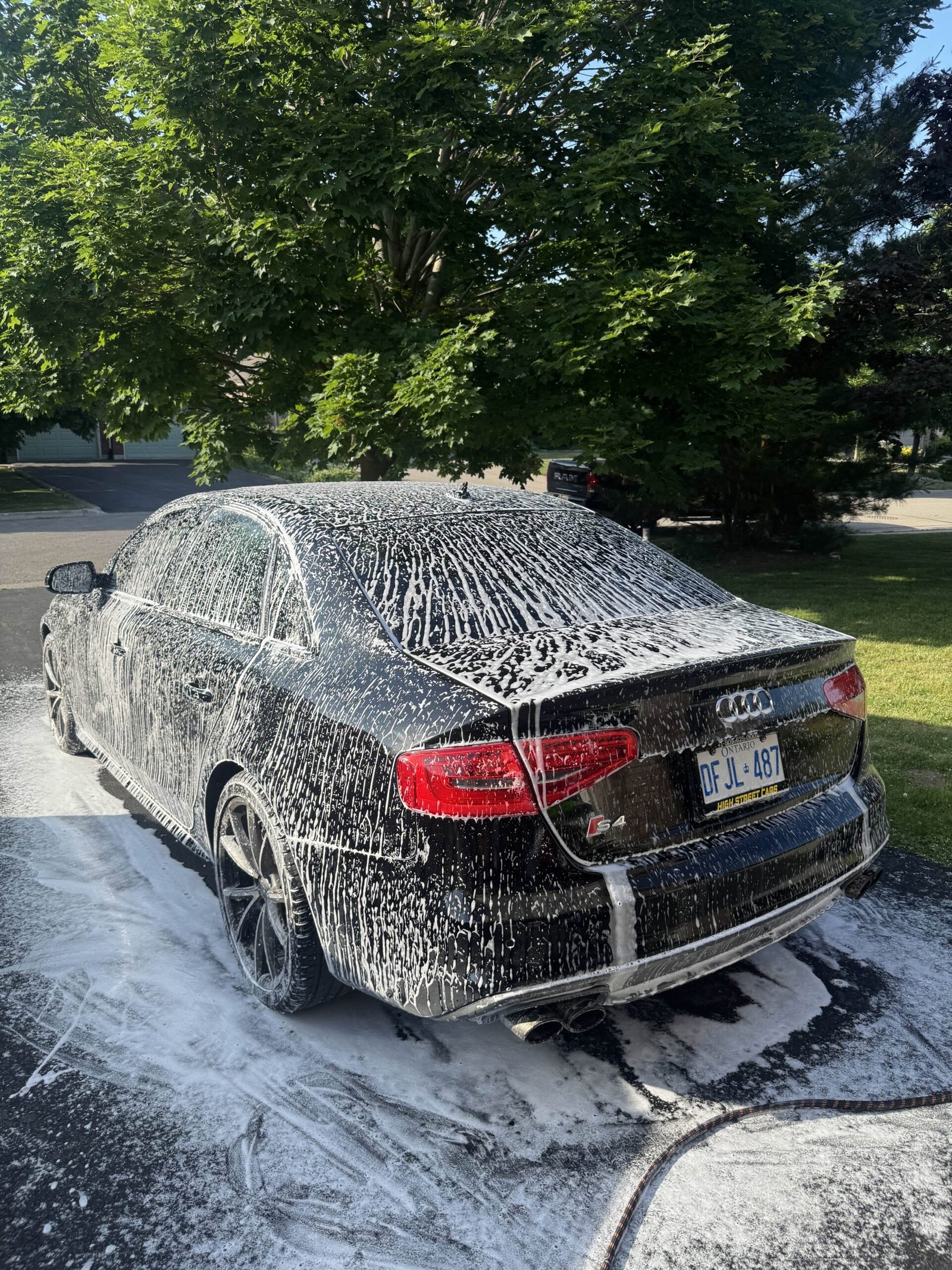 Audi S4 being cleaned with snow foam rear view